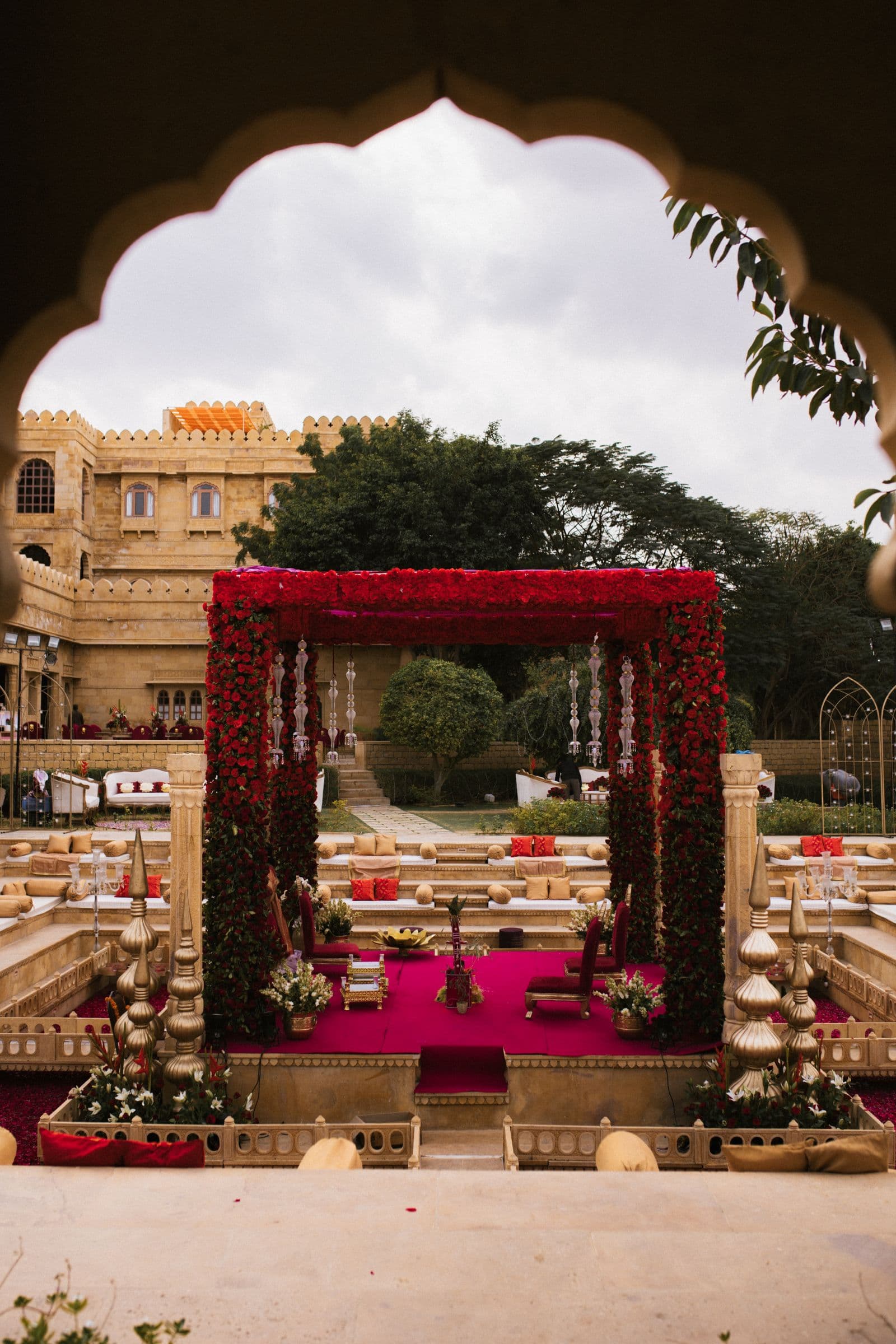 Grand floral mandap stage framed by a decorated archway